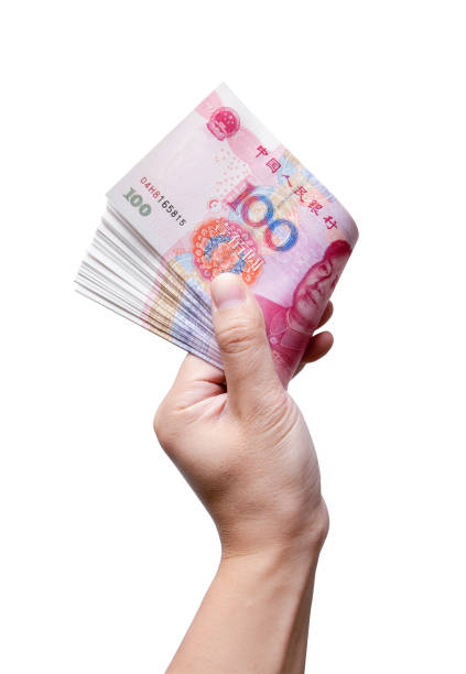 istock Holding Chinese Yuan Note (clipping path) isolated on white background 864325718