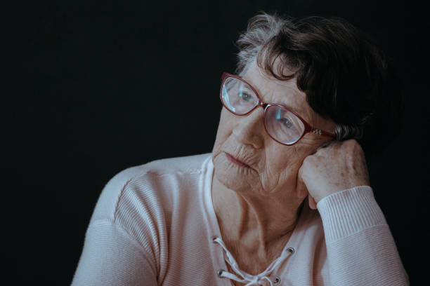 istock Senior woman against black background 864334552