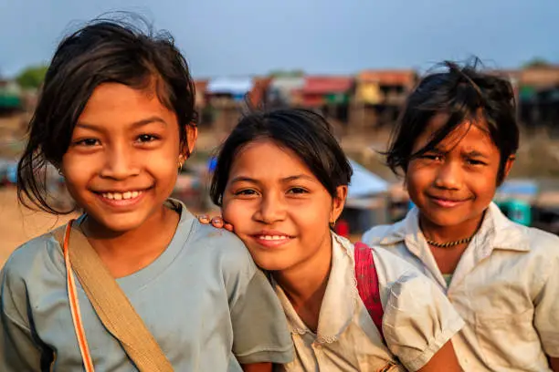 Happy Cambodian schoolgirls near Tonle Sap, Cambodia