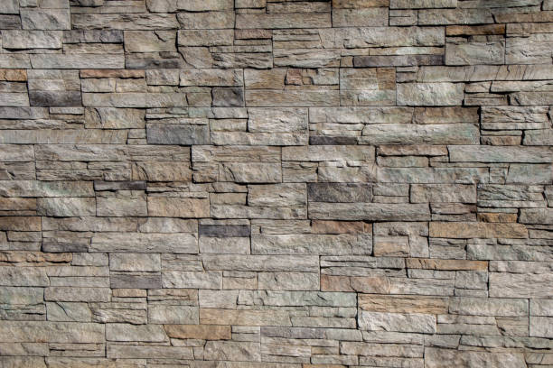 istock Wall made of the same type of stones 864338550