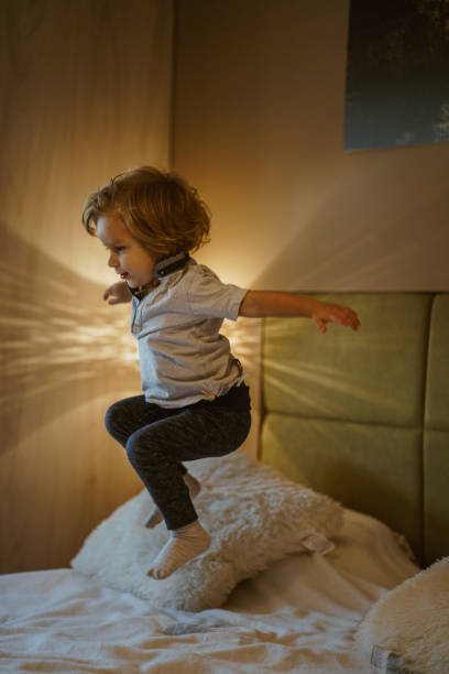 istock Cute little boy having fun in parents bedroom 864343152