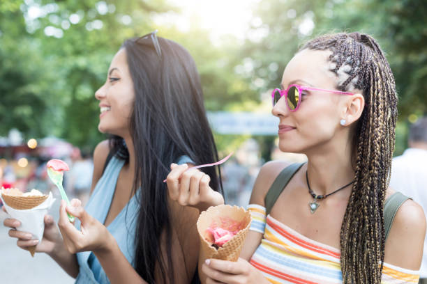 istock Girls having fun and eating ice cream 864346324