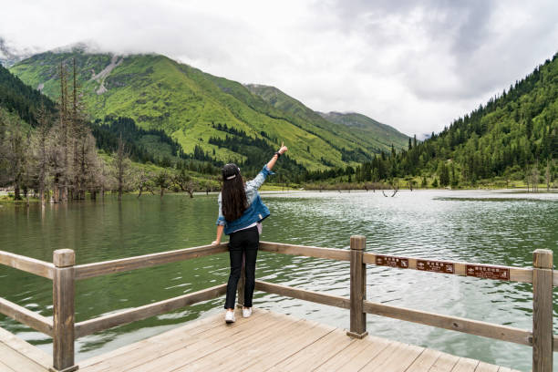 istock Women standing by the lake 864350878