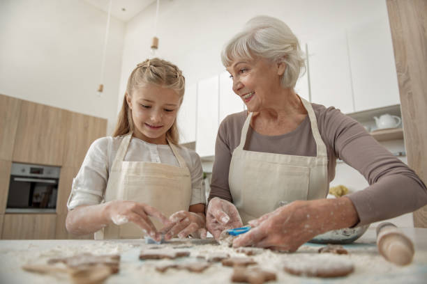 istock Happy granny enjoying baking process with her granddaughter 864351428