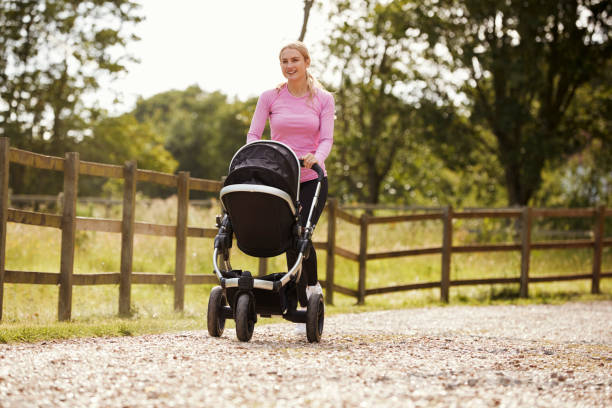 istock Mother Exercising By Running Whilst Pushing Baby Buggy 864351582