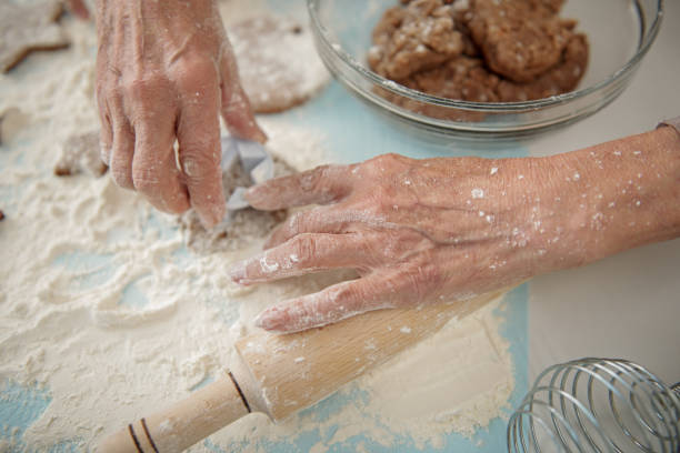 istock Cheerful granny baking cookies in kitchen 864351752