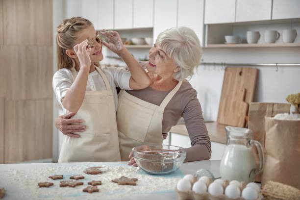 istock Carefree child enjoying baking process with her grandmother 864352286