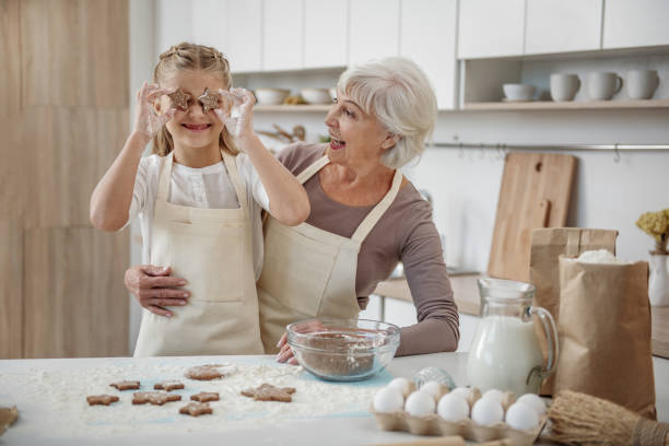 istock Joyful granny and child are having fun in the kitchen 864352354