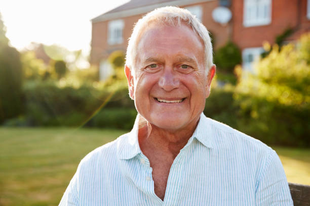 istock Senior Man Sitting On Garden Bench In Evening Sunlight 864358142