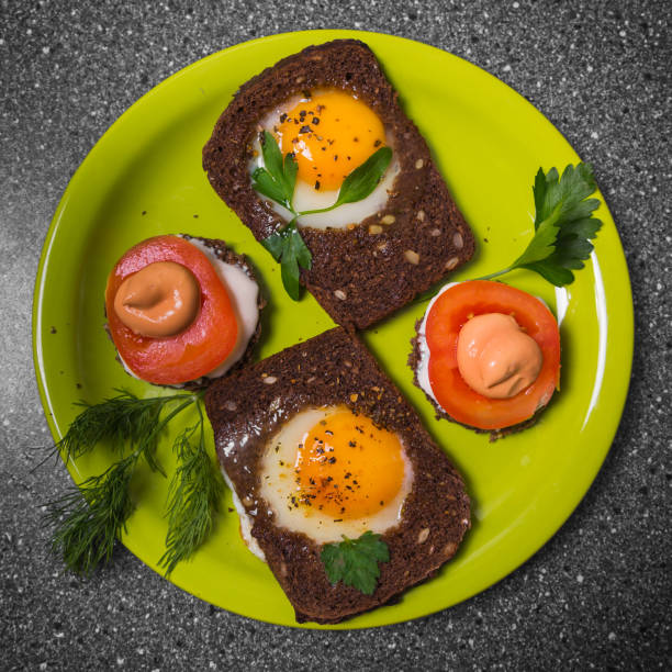 Breakfast -  toast with processed cheese tomato, fried eggs , fried eggs,  on a gray  background. Flat lay. Top view.