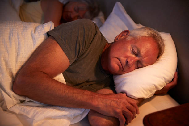 istock Peaceful Senior Man Asleep In Bed At Night 864363476