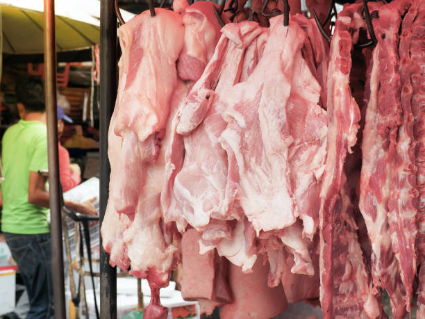 istock Fresh pork fillet hanging on display 864366774