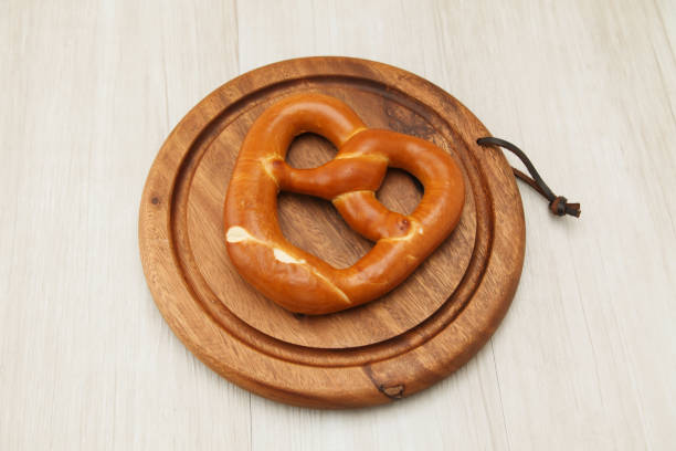 istock pretzel German bread on wood plate isolated on table 864366938