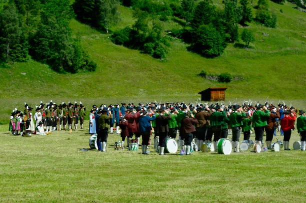 Austria, Tyrol, Custom Feichten, Tyrol, Austria - June 22, 2014: Unidentified people in traditional outfit in Dirndl and Lederhose by field mass in Kaunertal valley dirndl traditional clothing austria traditional culture stock pictures, royalty-free photos & images