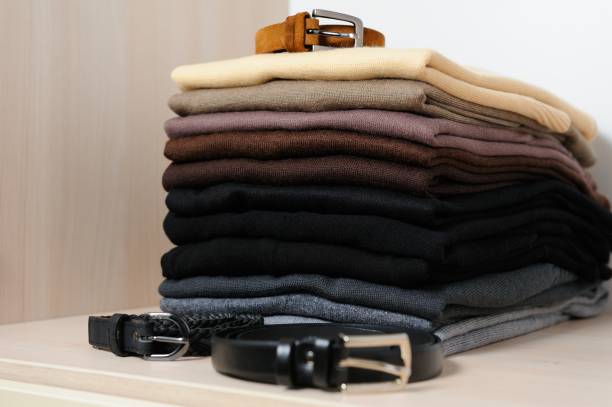 istock Different knitted sweaters  in a wardrobe, close up. Concept order in the closetwardrobe 864378314