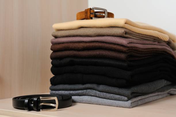 istock Different knitted sweaters  in a wardrobe, close up. Concept order in the closetwardrobe 864378328