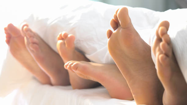 Family foot in Bed have Fun Sunday Morning Family foot in Bed have Fun Sunday Morning bed human foot couple two parent family stock pictures, royalty-free photos & images