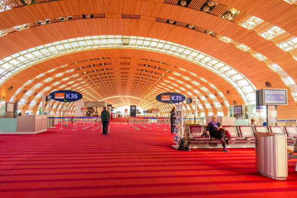 Unidentified people at the hall of departure in the terminal of Roissy Charles de Gaulle International Airport, Paris, France, is a hub for the French airline Air France stock photo