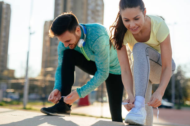 istock Runners tying running shoes and getting ready to run 864384620
