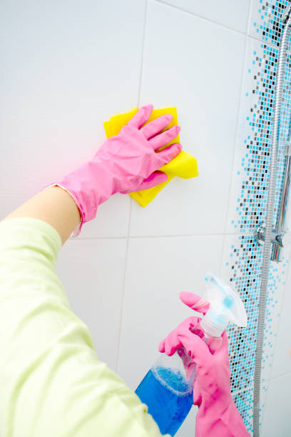istock A woman cleaning bathroom at home 864388300