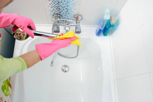 istock A woman cleaning bathroom at home 864388502
