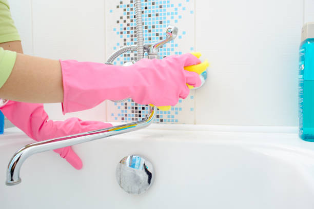 istock A woman cleaning bathroom at home 864388516