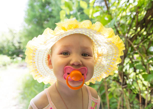 istock Cute baby with a pacifier in the sun 864391094
