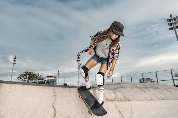 istock Young female skateboarder in skateboard park 864403748