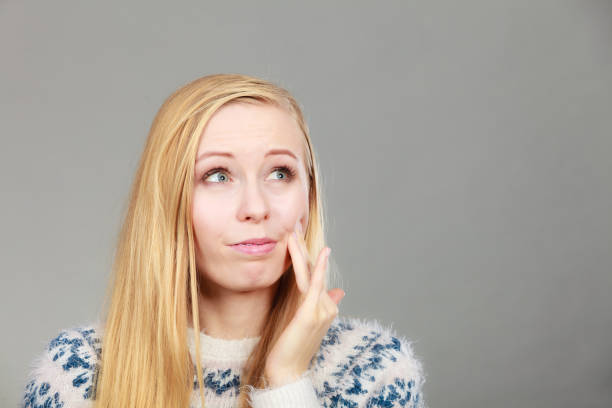 istock Woman having toothache touching her cheek 864406618