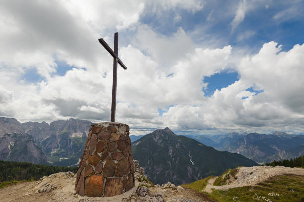 istock Mountain landscape with cross ,blue sky and clouds. 864408852