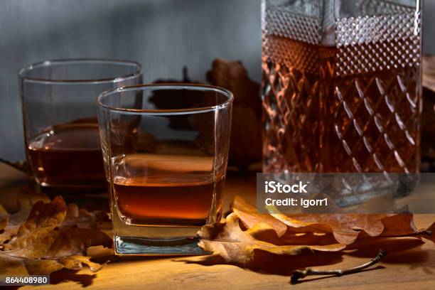 Whiskey On A Old Wooden Table Stock Photo - Download Image Now - Alcohol - Drink, Amber, Autumn