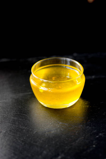 istock Nice ghee in a glass bowl over black background. 864409118