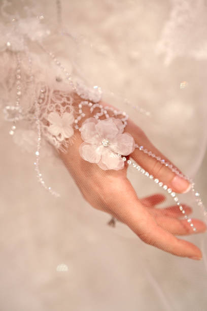 istock Bride hand with lace wedding dress 864409298