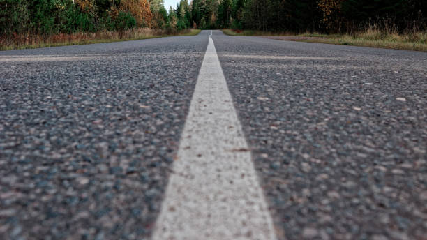 istock Road through autumn forest 864411916