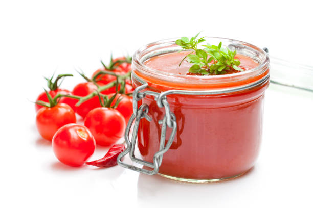 istock Glass  jar with tomato paste and cherry tomatoes isolated on white background 864414536