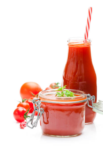 istock Glass  jar and bottle with tomato paste and juice with cherry tomatoes isolated on white background 864415448