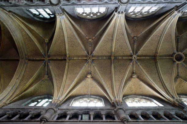 istock Gothic cross vault in yellow bricks seen from below 864415746