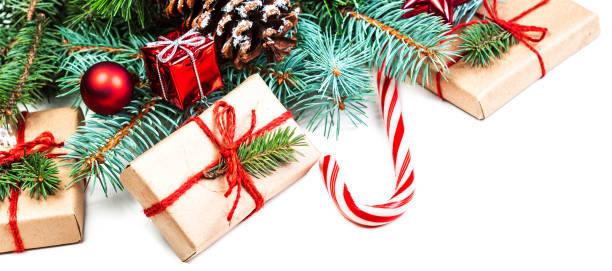 istock Christmas or New Year decorations background with pine cones, fir branches and gift boxes isolated on white. Vintage Merry Christmas concept. Flat lay, top view
