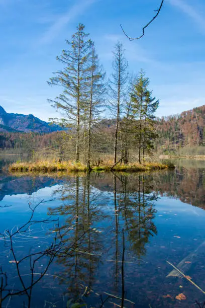Island in a mountain lake in autumn, almsee in austria