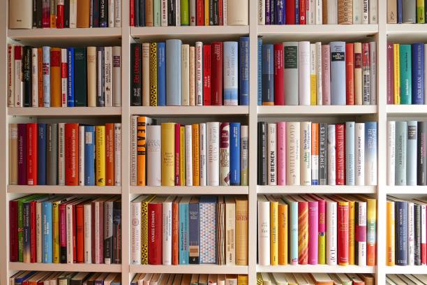 biblioteca: vista di file colorate di libri - book book spine in a row library foto e immagini stock