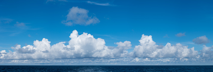 High resolution panoramic cloudscape of sunny clouds over the ocean