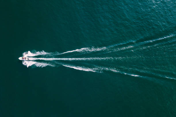 istock Motor Boat with Waves on a lake seen from above 864426184