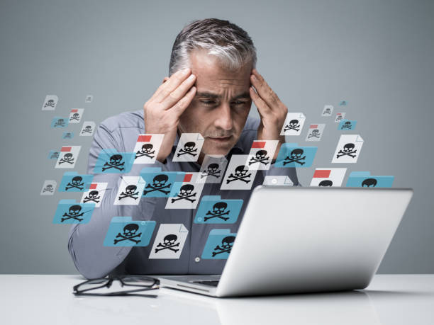 Virus and malwares Businessman working with a computer full of viruses, infected files and malwares: he is frustrated with head in hands e mail spam stock pictures, royalty-free photos & images