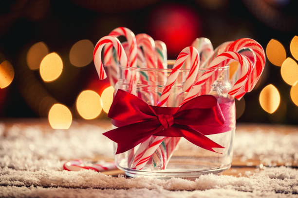 Candy Canes Candy canes in front of Christmas tree Candy Cane CANDY stock pictures, royalty-free photos & images
