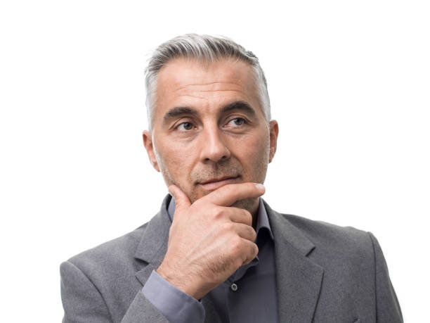 istock Smart businessman thinking with hand on chin 864428514