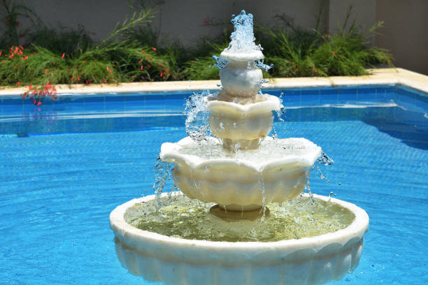 A multi-tiered fountain in a blue pool