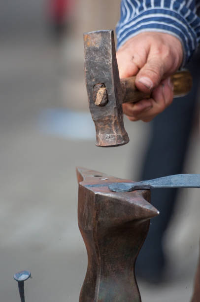 istock metalsmith hammering the iron 864429666