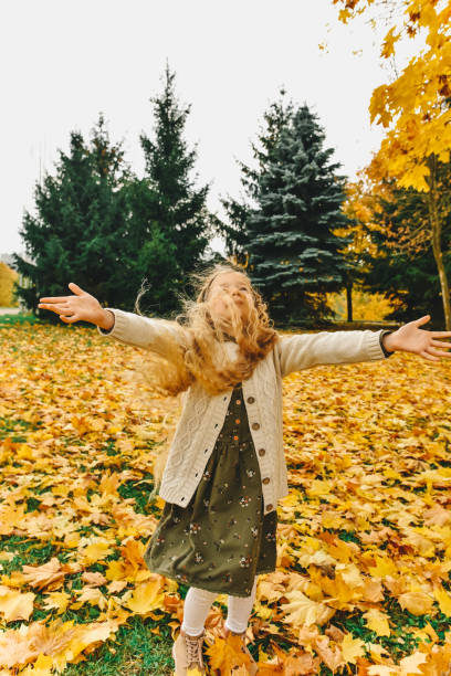 istock autumn child in the park 864432700