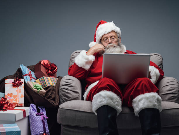 istock Santa Claus connecting with a laptop 864433408
