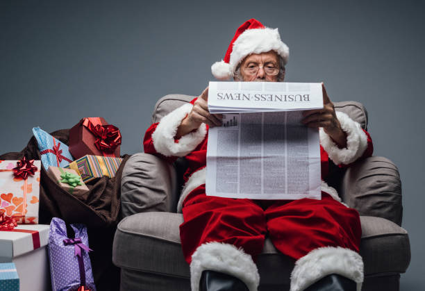 istock Santa Claus reading business news 864433498